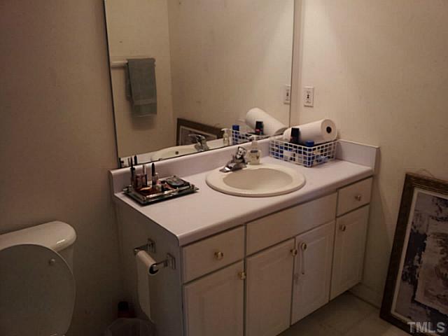 2052 Buffalo Way Durham, NC 27704 - Photo 16 of 20 a bathroom with a sink toilet and mirror