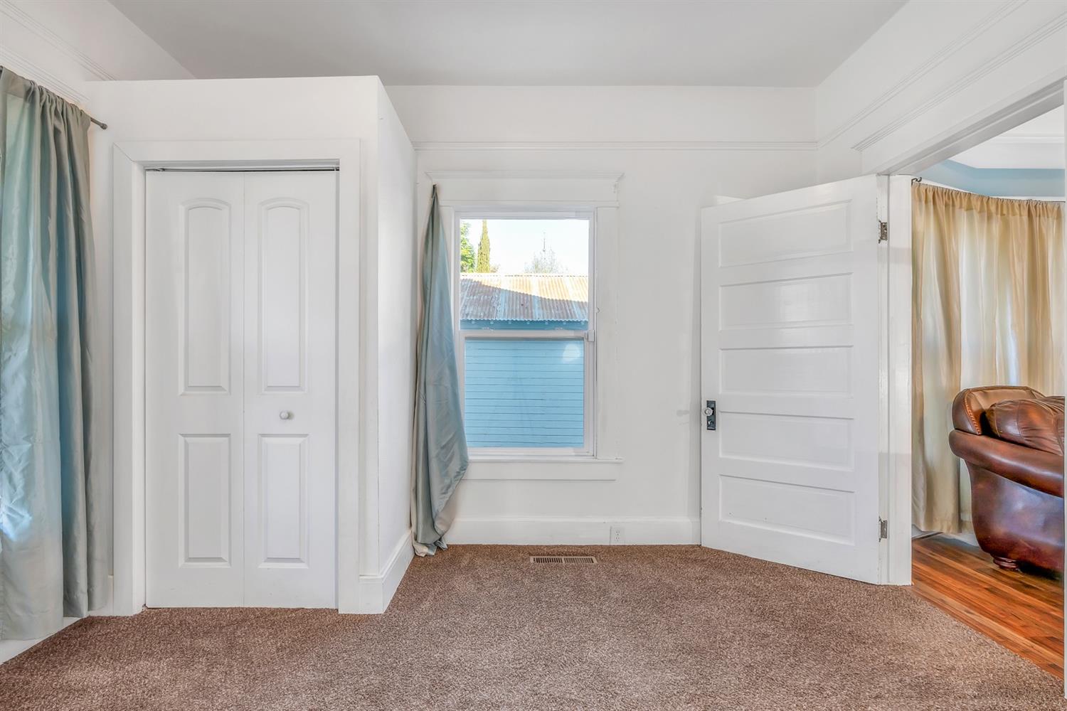 1158 K Street Reedley, CA 93654 - Photo 14 of 31 a view of an empty room with closet and a window