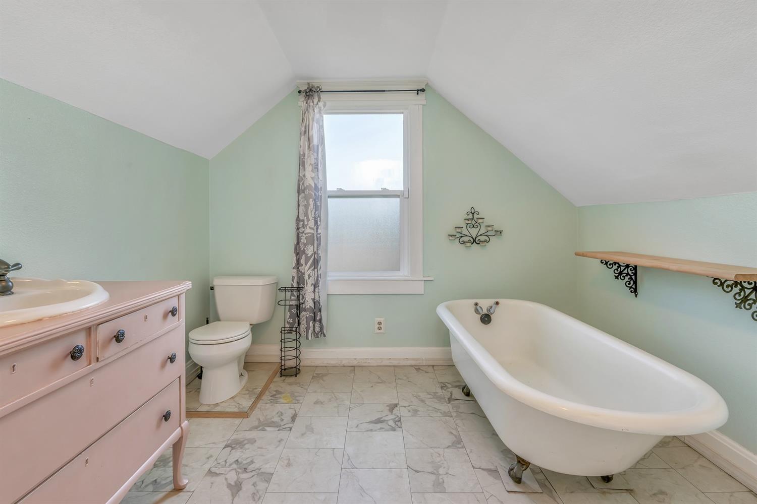 1158 K Street Reedley, CA 93654 - Photo 22 of 31 a bathroom with a toilet sink and mirror