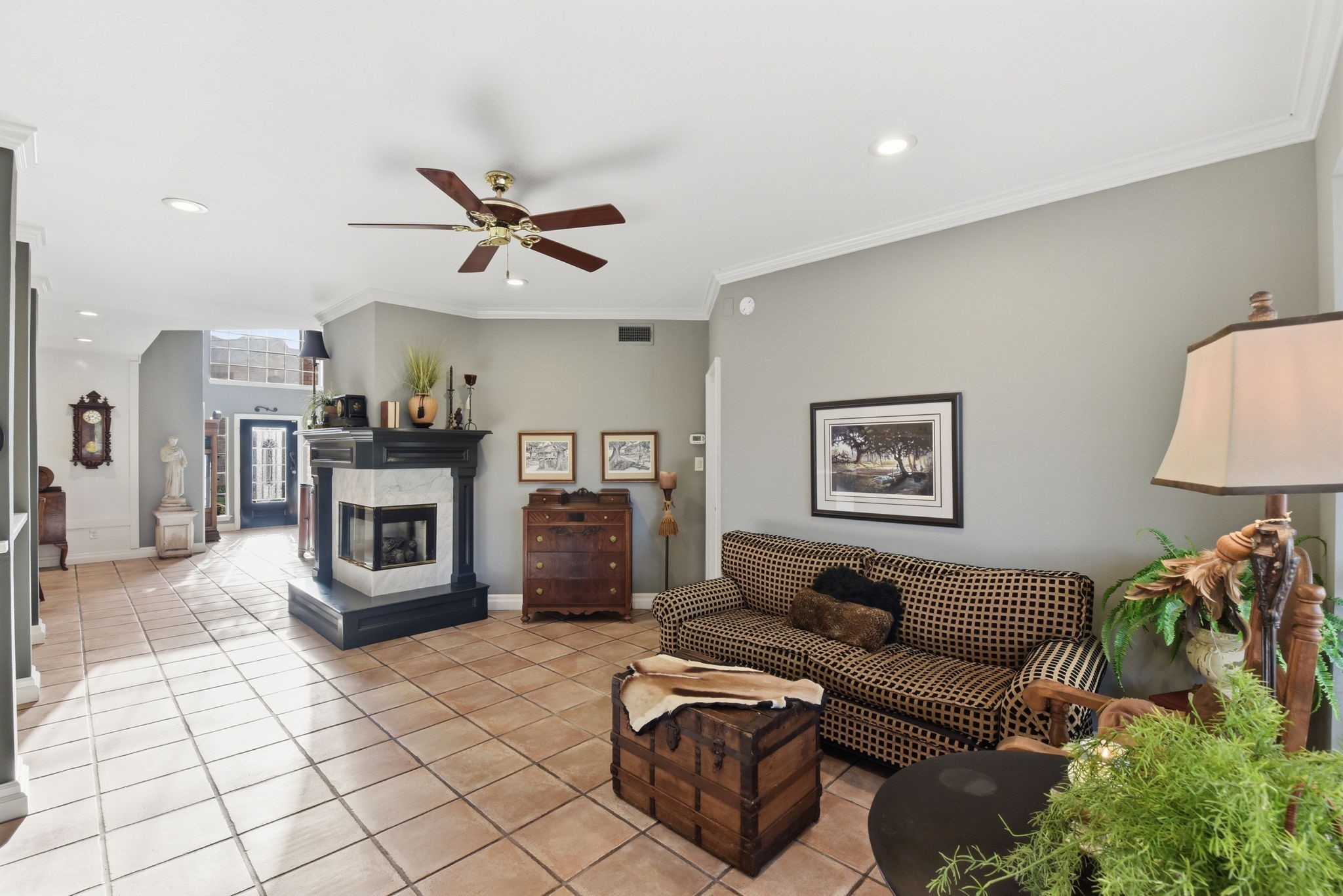 16322 Cranwood Drive Spring, TX 77379 - Photo 14 of 42 Experience cozy elegance with this inviting space featuring a stunning double-sided gas fireplace and charming corner mantle, perfect for warmth and style.