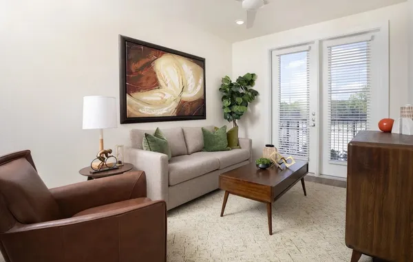 a living room with furniture and a potted plant