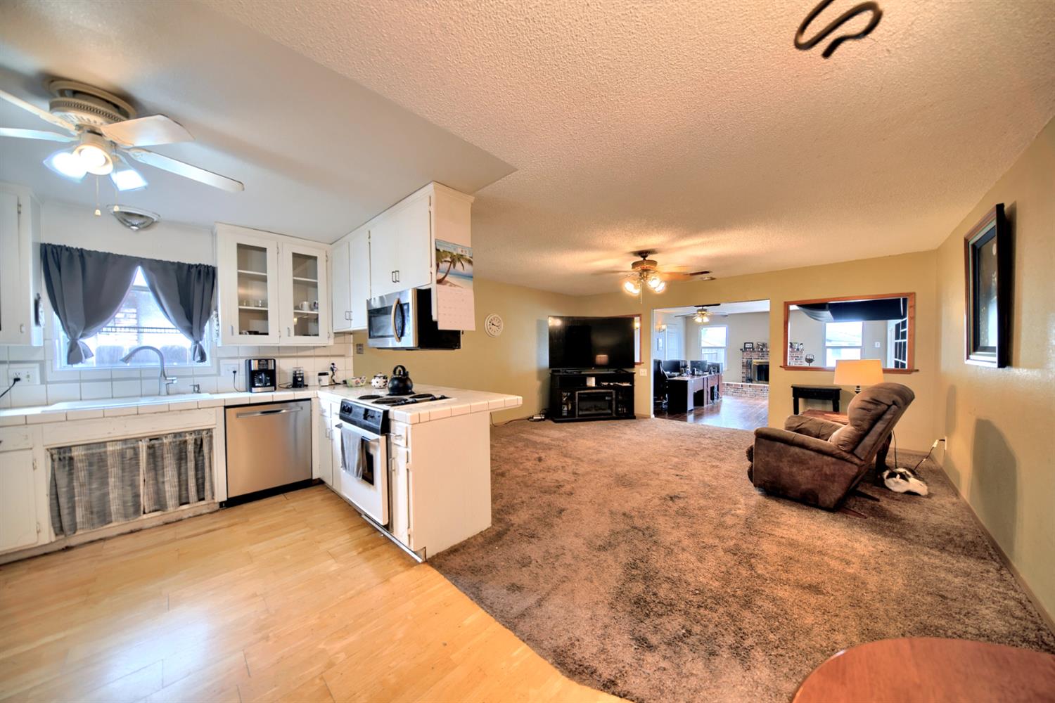 6521 Narcisco Way Hughson, CA 95326 - Photo 16 of 40 a large white kitchen with cabinets a sink and a stove
