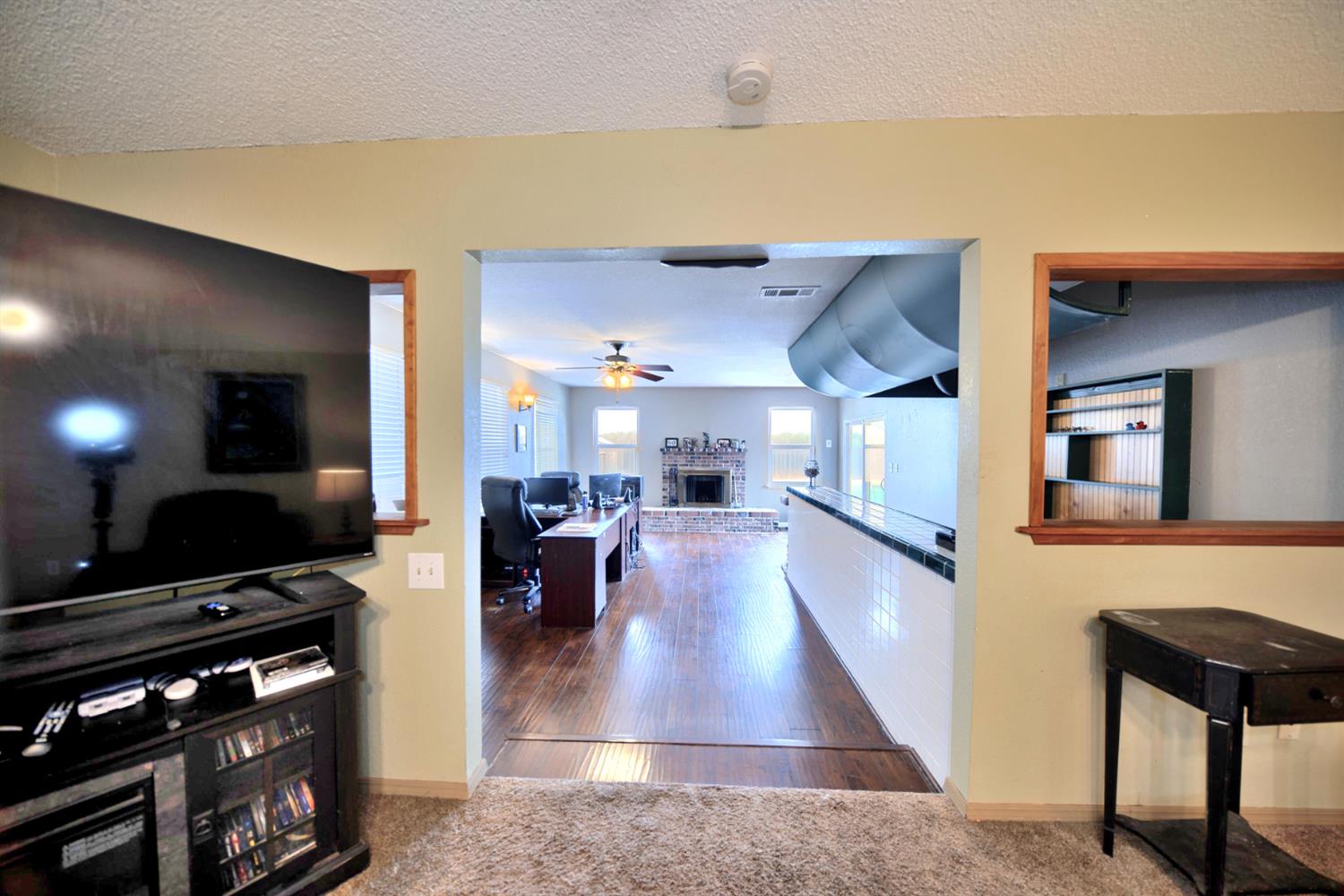 6521 Narcisco Way Hughson, CA 95326 - Photo 18 of 40 a view of a living room and kitchen with furniture