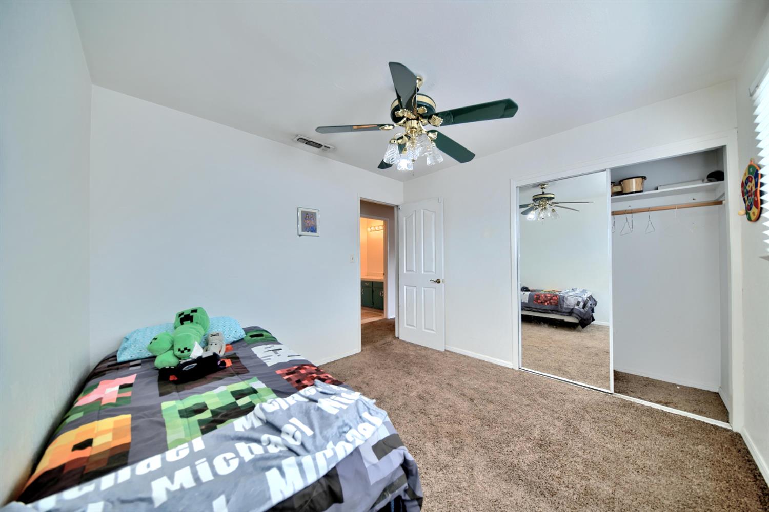 6521 Narcisco Way Hughson, CA 95326 - Photo 23 of 40 a bedroom with bed and a chandelier