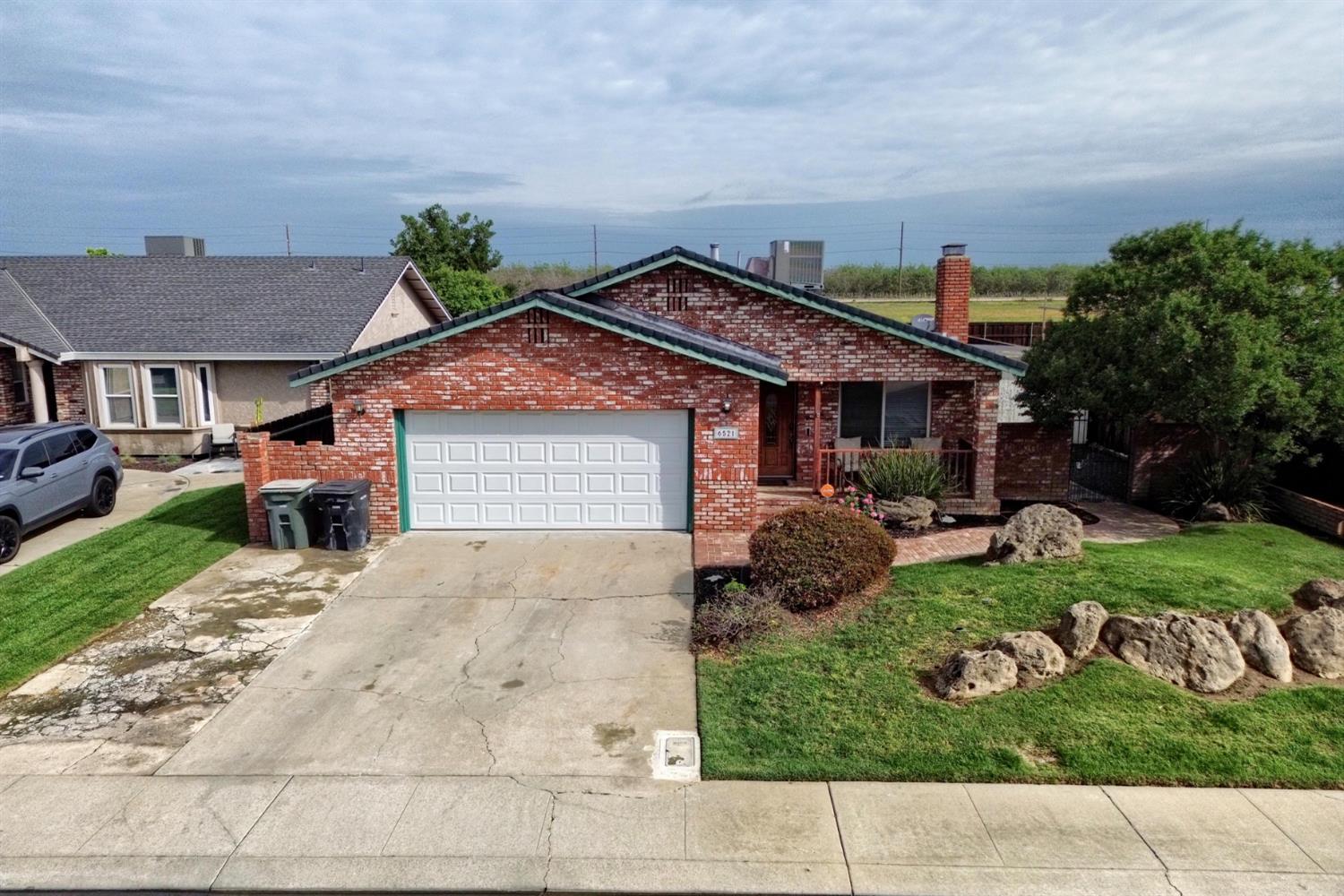 6521 Narcisco Way Hughson, CA 95326 - Photo 3 of 40 a front view of a house with garden