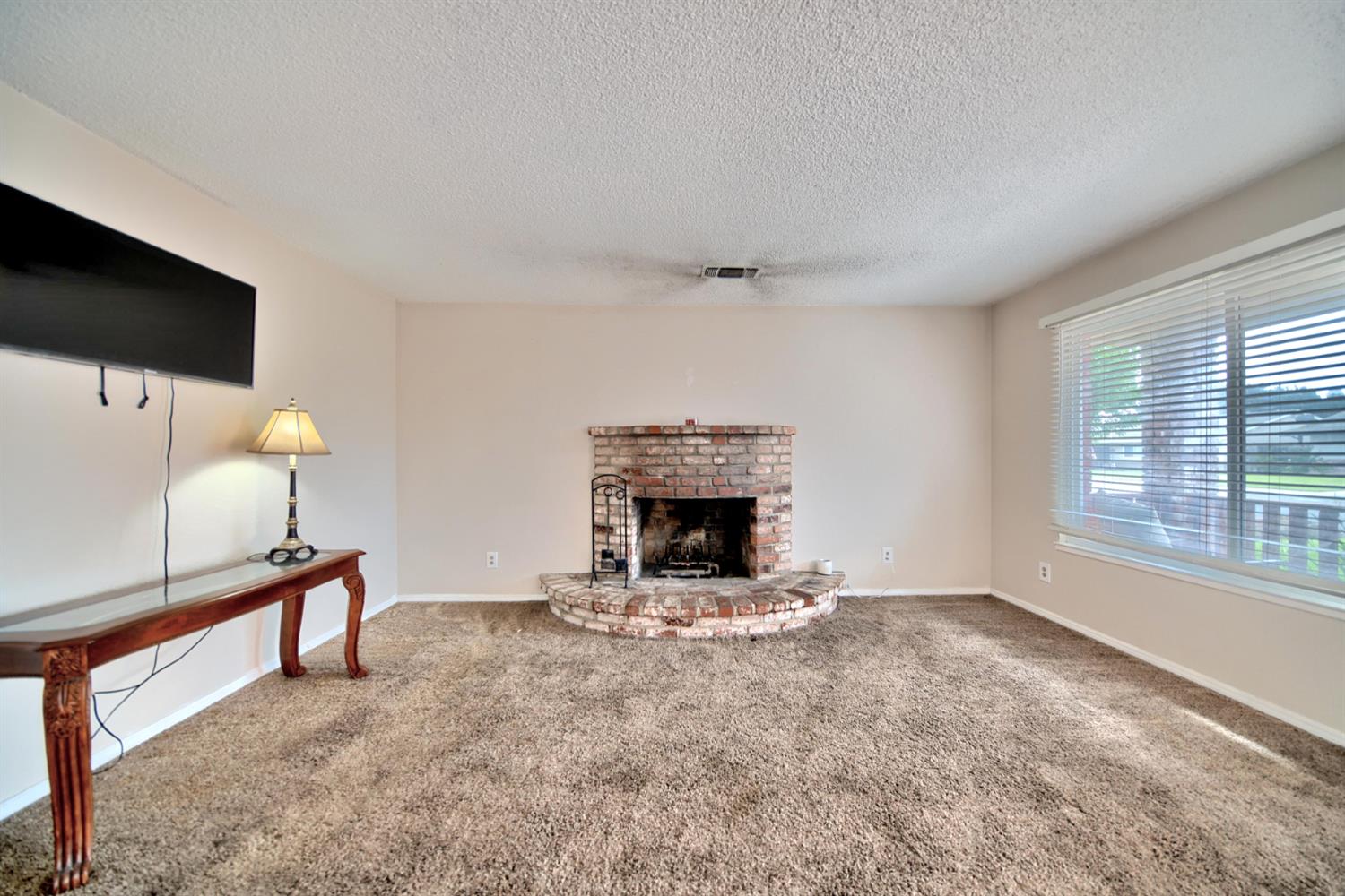 6521 Narcisco Way Hughson, CA 95326 - Photo 9 of 40 a living room with furniture and a fireplace