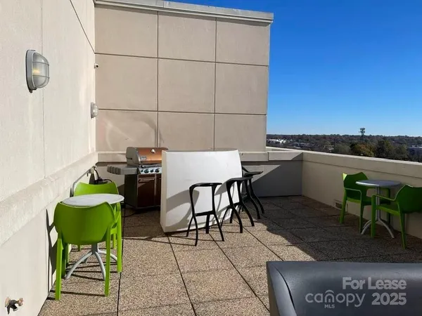 a view of a terrace with couches and sky view
