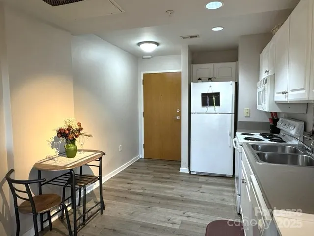a kitchen with a table and chairs in it