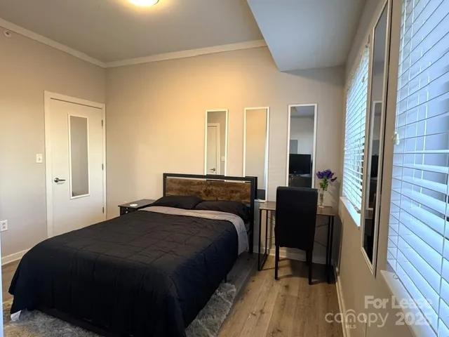 a bedroom with a bed and a mirror