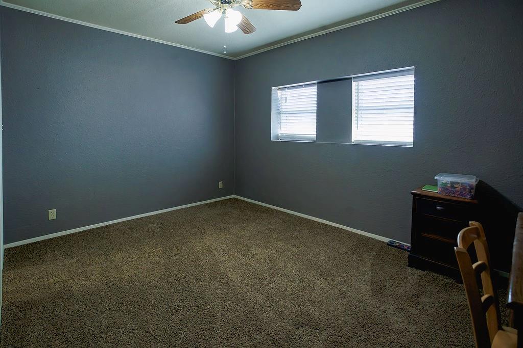 1308 West 14th Street Cisco, TX 76437 - Photo 17 of 39 an empty room with a workspace