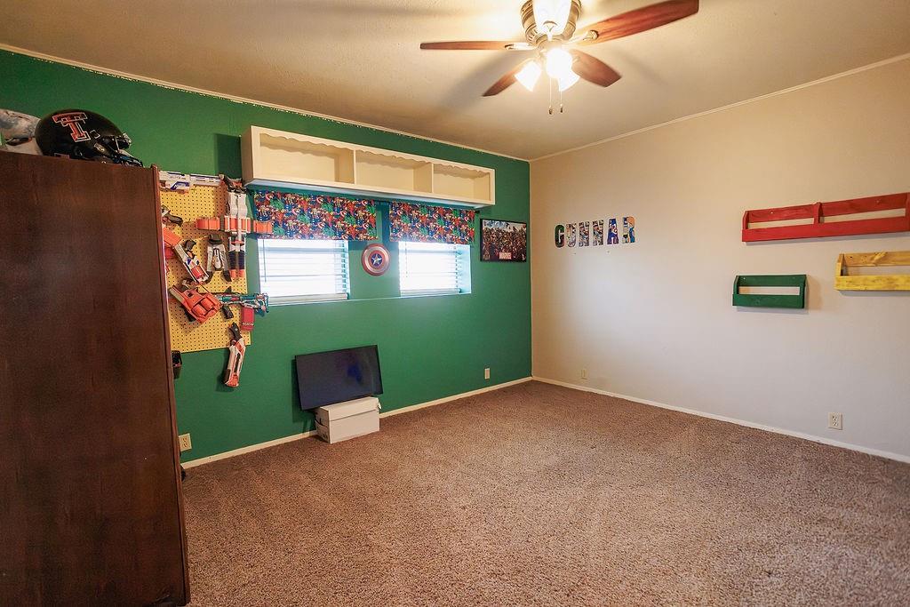 1308 West 14th Street Cisco, TX 76437 - Photo 21 of 39 en empty room with window and ceiling fan