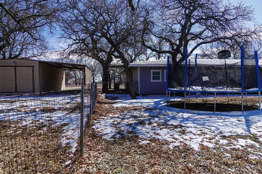 1308 West 14th Street Cisco, TX 76437 - Photo 26 of 39 a wooden bench sitting in front of a house