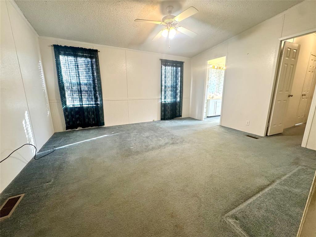 211 West F Street Munday, TX 76371 - Photo 11 of 27 an empty room with windows and closet