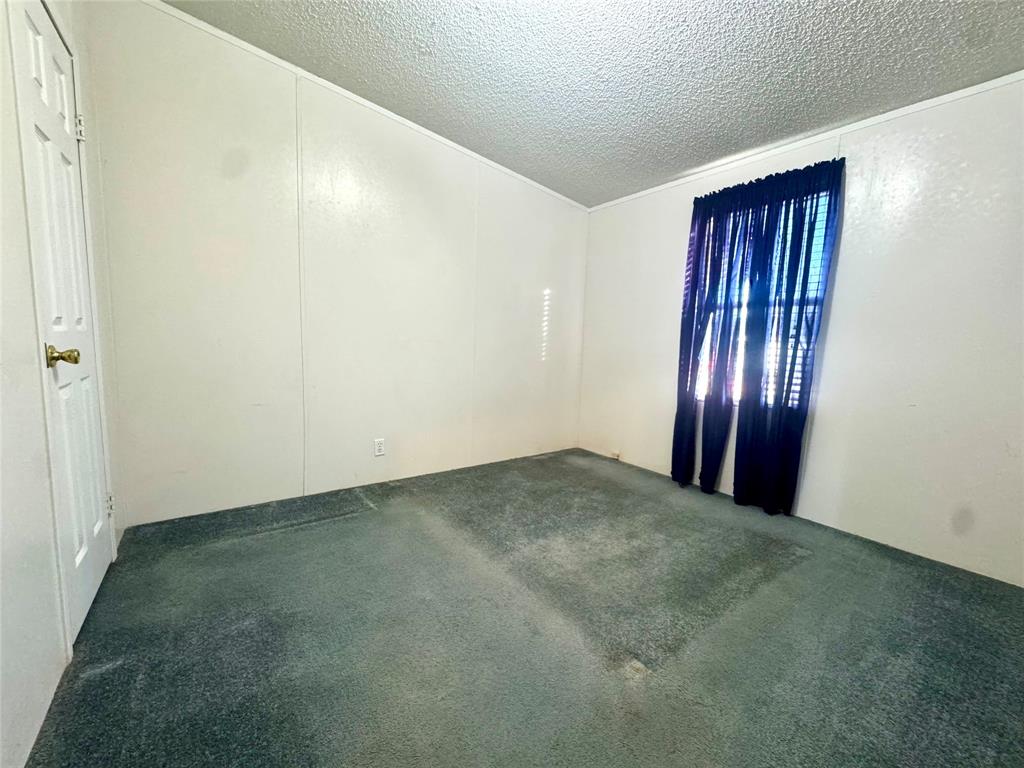 211 West F Street Munday, TX 76371 - Photo 19 of 27 an empty room with windows and stairs