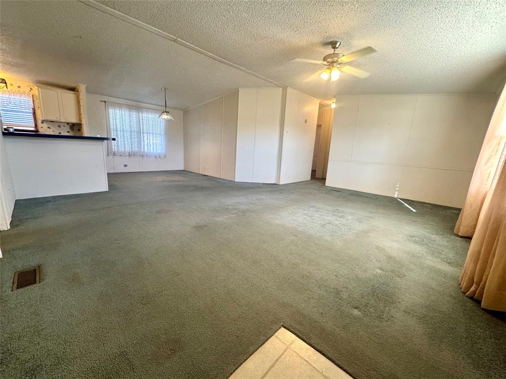 211 West F Street Munday, TX 76371 - Photo 2 of 27 a view of a livingroom with a fireplace