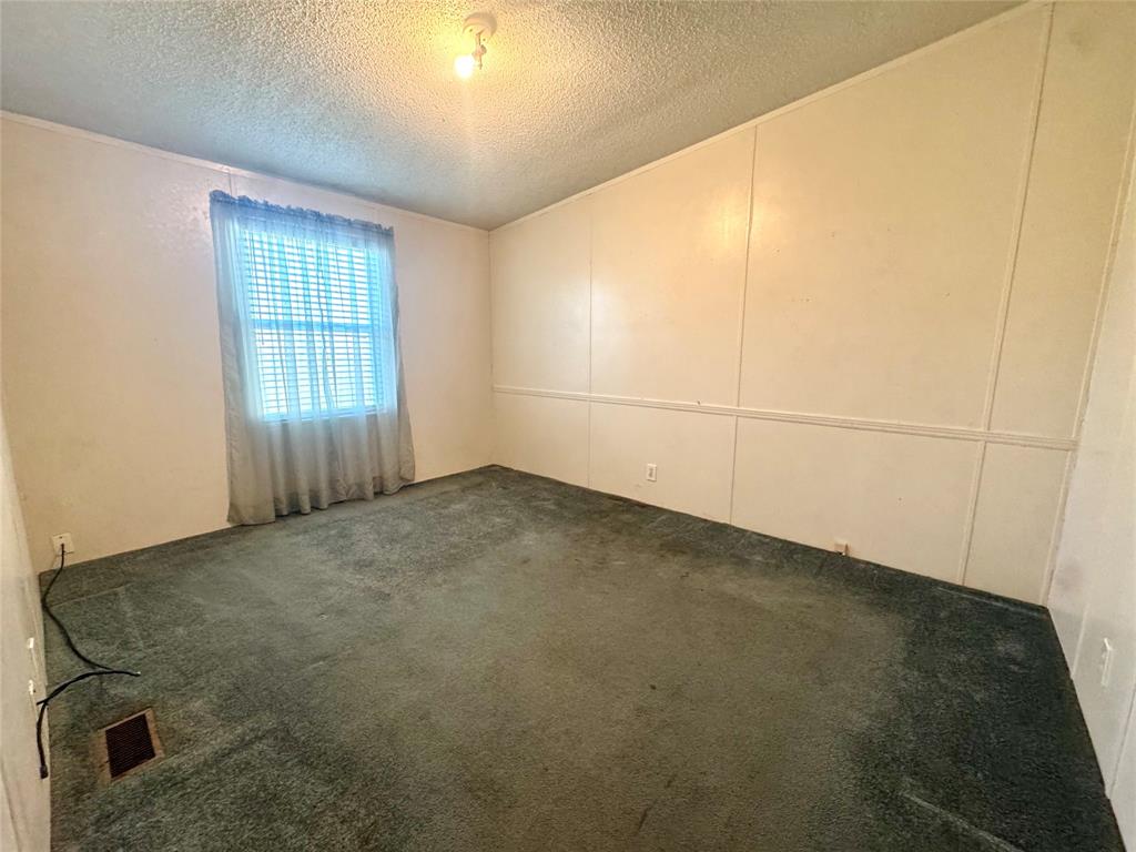 211 West F Street Munday, TX 76371 - Photo 21 of 27 an empty room with windows