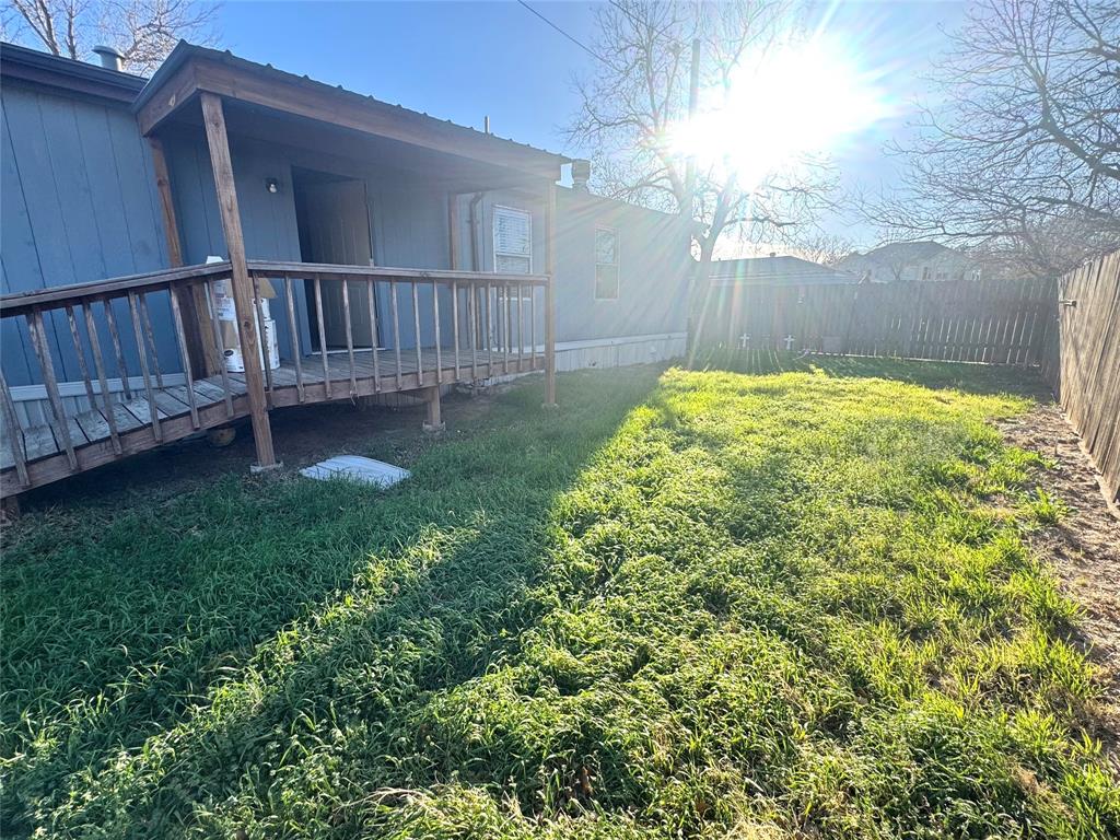 211 West F Street Munday, TX 76371 - Photo 22 of 27 a view of a backyard with a small cabin