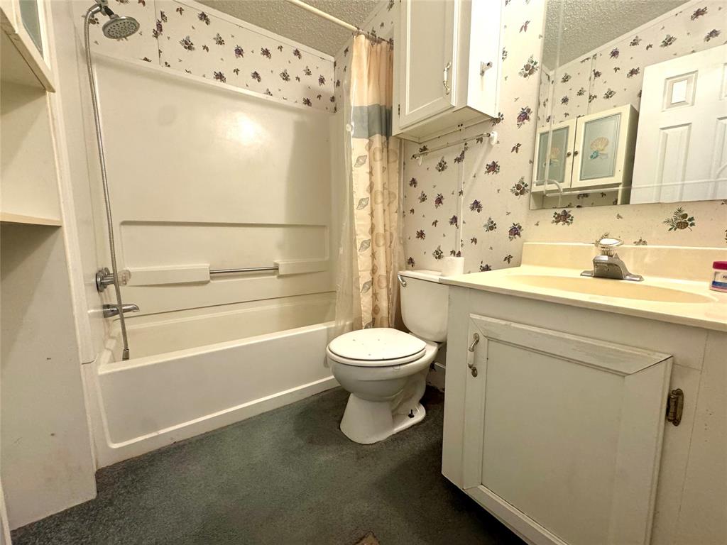 211 West F Street Munday, TX 76371 - Photo 26 of 27 a bathroom with a sink toilet and shower