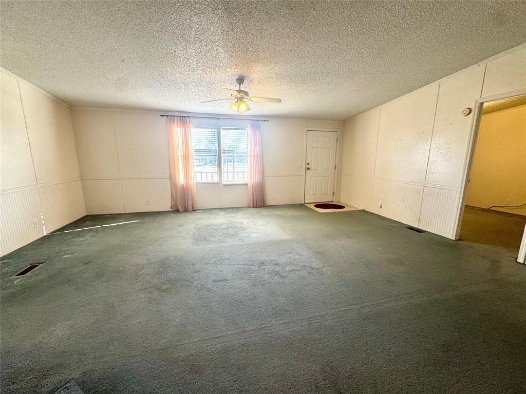211 West F Street Munday, TX 76371 - Photo 4 of 27 a view of an empty room with a window