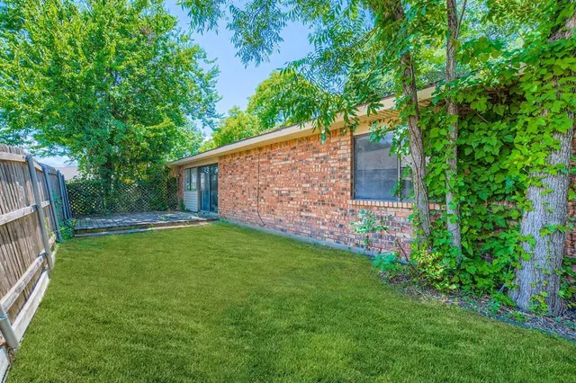 a backyard of a house with lots of green space