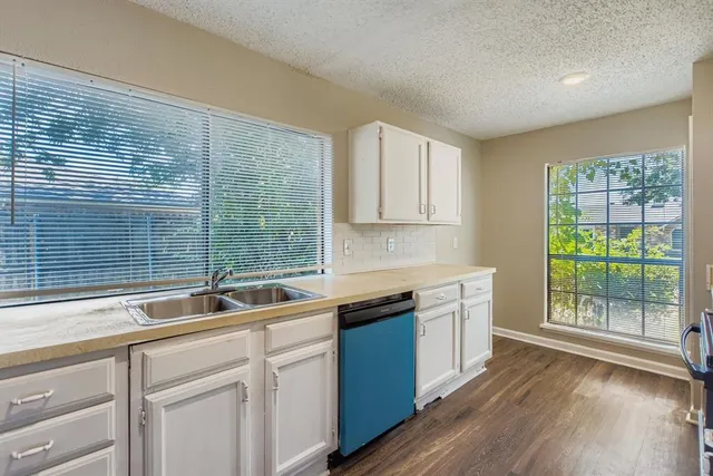 a kitchen with a sink and cabinets