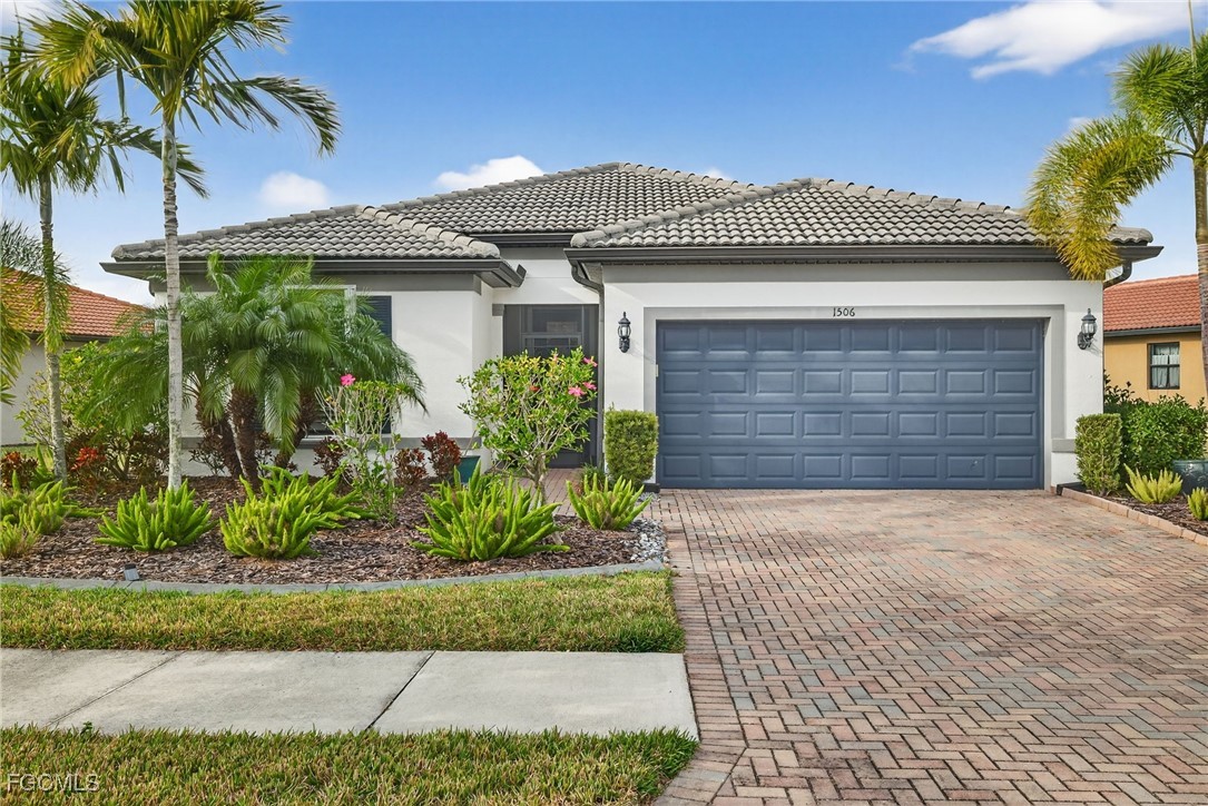 1506 Hyssop Loop North Port, FL 34289 - Photo 1 of 32 a front view of a house with a garden