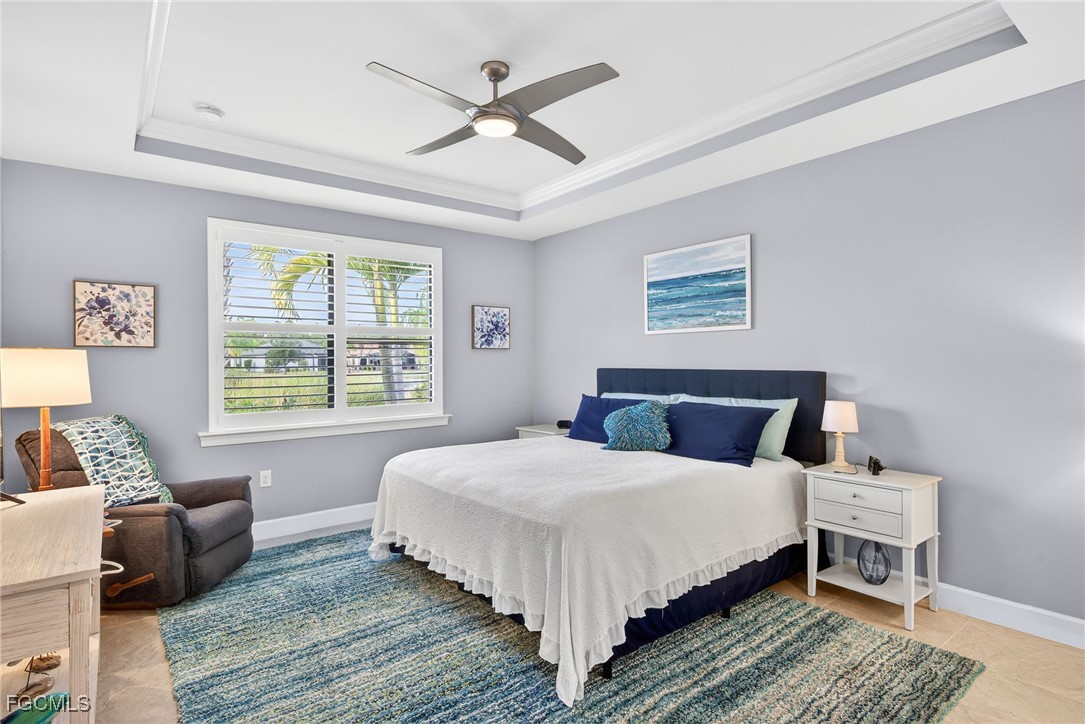 1506 Hyssop Loop North Port, FL 34289 - Photo 14 of 32 a bedroom with a bed a couch and a window