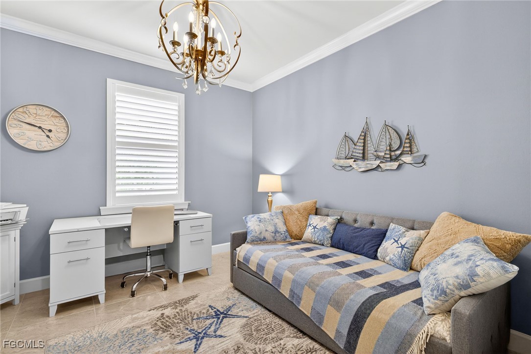 1506 Hyssop Loop North Port, FL 34289 - Photo 16 of 32 a bedroom with a bed and a chandelier