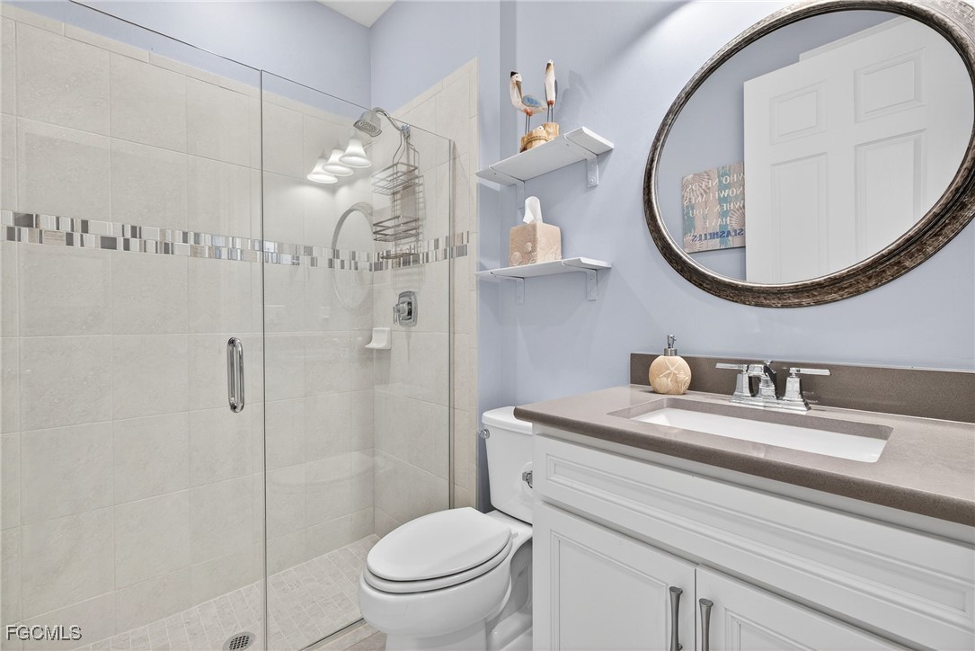 1506 Hyssop Loop North Port, FL 34289 - Photo 19 of 32 a bathroom with a sink mirror vanity and toilet