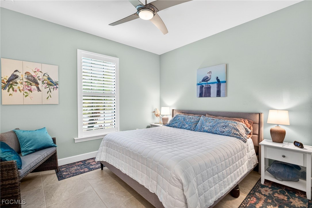 1506 Hyssop Loop North Port, FL 34289 - Photo 20 of 32 a bedroom with a bed a couch and a window