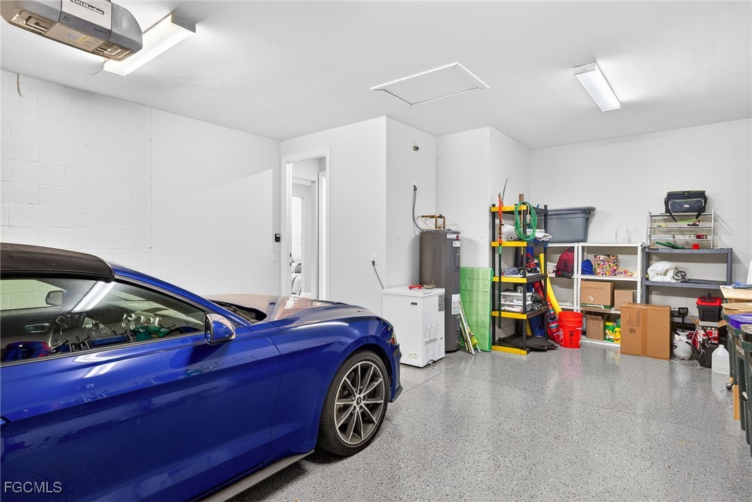 1506 Hyssop Loop North Port, FL 34289 - Photo 22 of 32 a utility room with dryer and cars