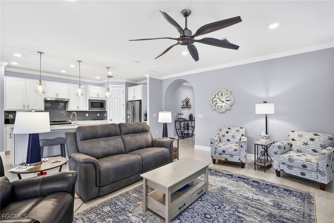 1506 Hyssop Loop North Port, FL 34289 - Photo 3 of 32 a living room with furniture kitchen view and a chandelier