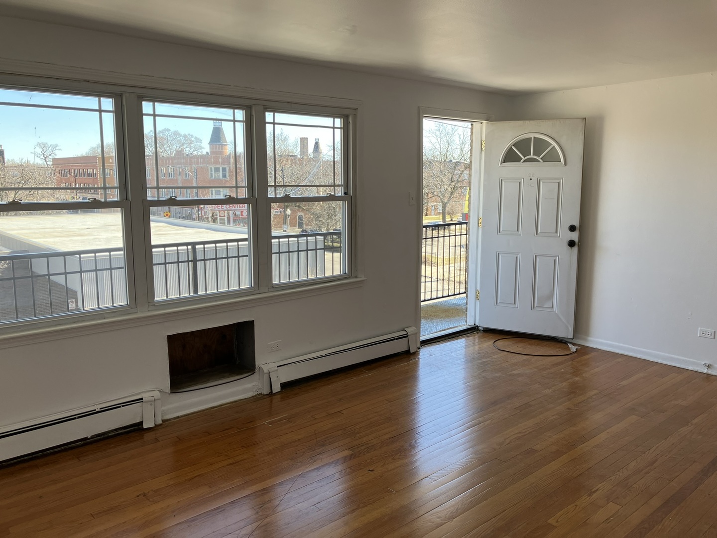 2404 East 79th Street Chicago, IL 60649 - Photo 16 of 22 an empty room with wooden floor and windows