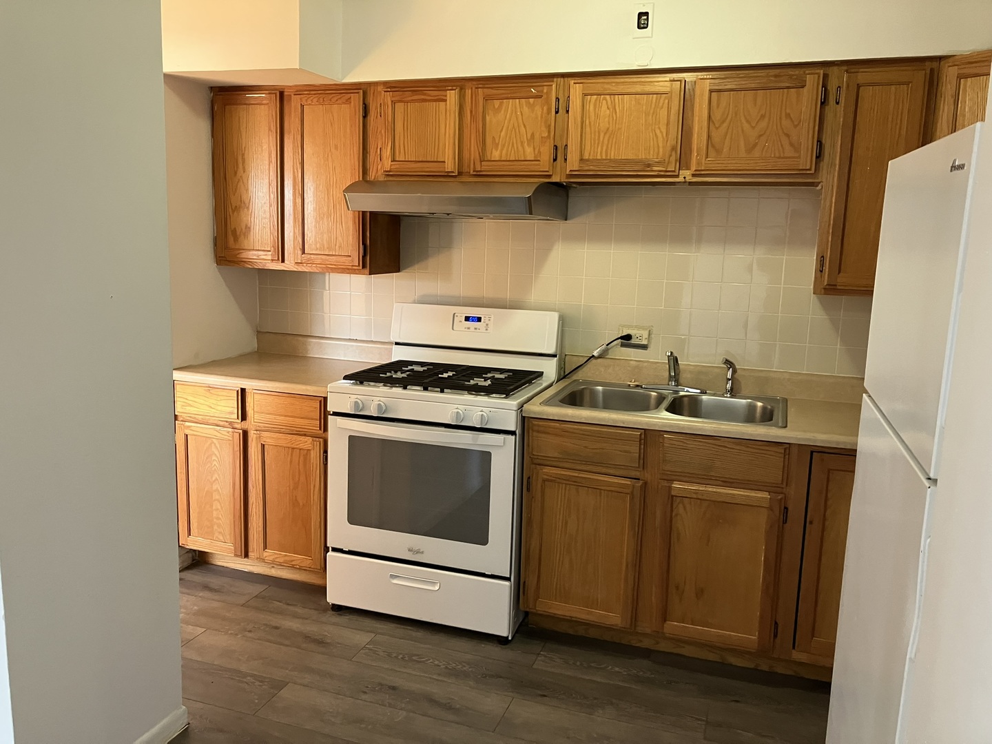 2404 East 79th Street Chicago, IL 60649 - Photo 18 of 22 a kitchen with granite countertop white cabinets and white appliances