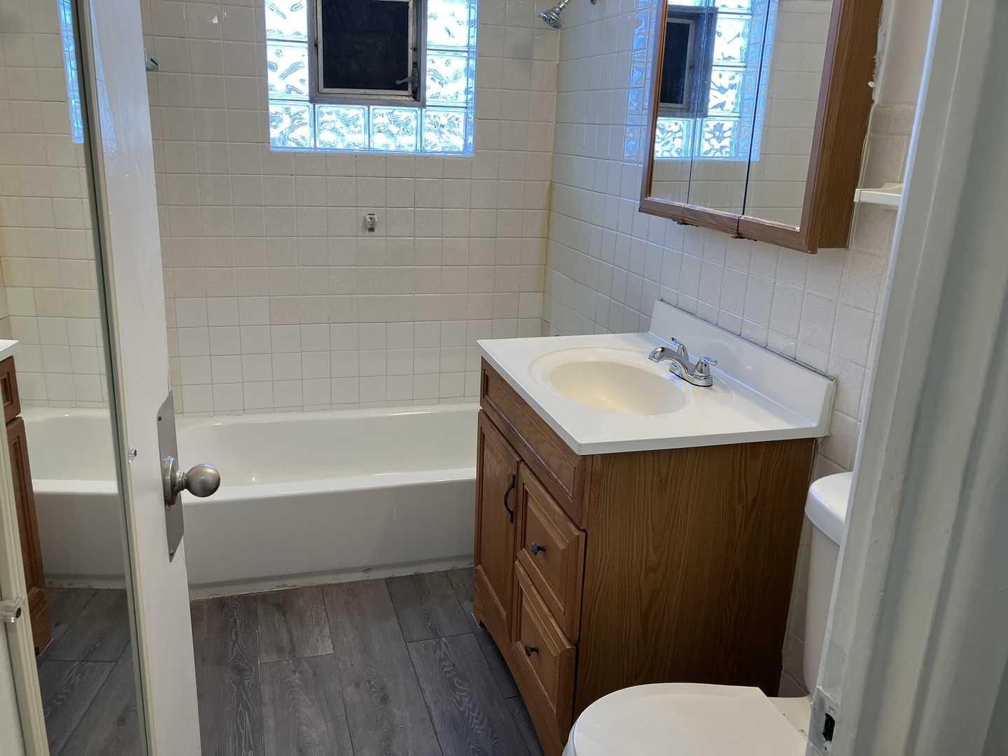 2404 East 79th Street Chicago, IL 60649 - Photo 20 of 22 a bathroom with a sink a toilet and shower