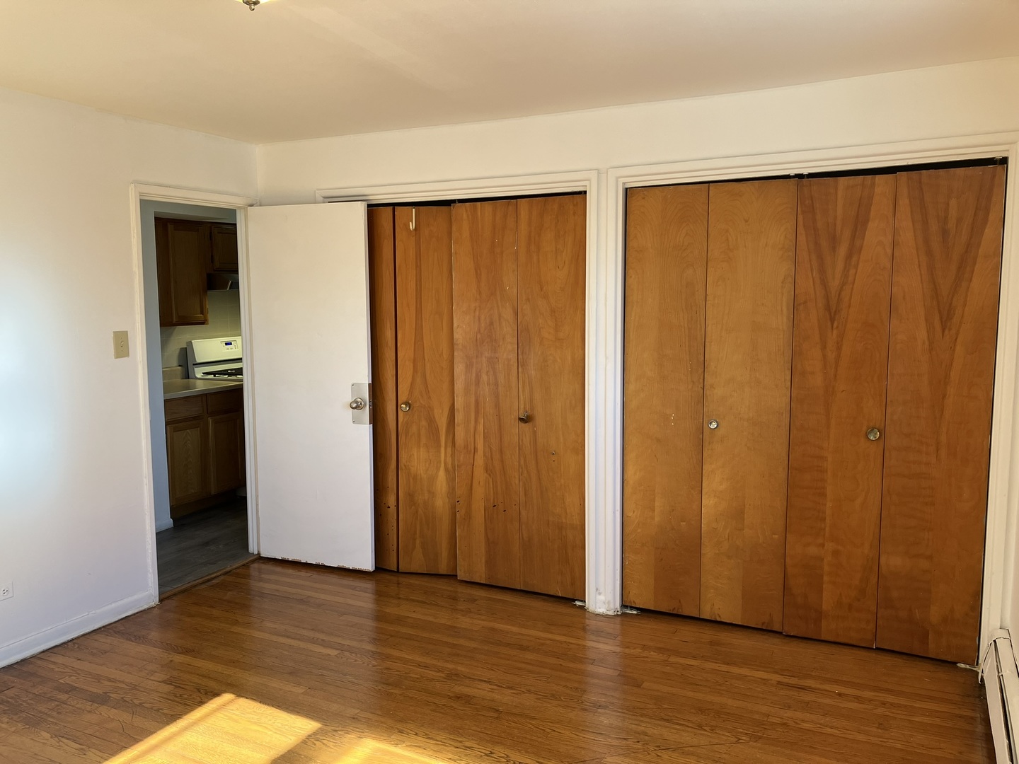 2404 East 79th Street Chicago, IL 60649 - Photo 22 of 22 a view of an empty room with wooden floor and a window