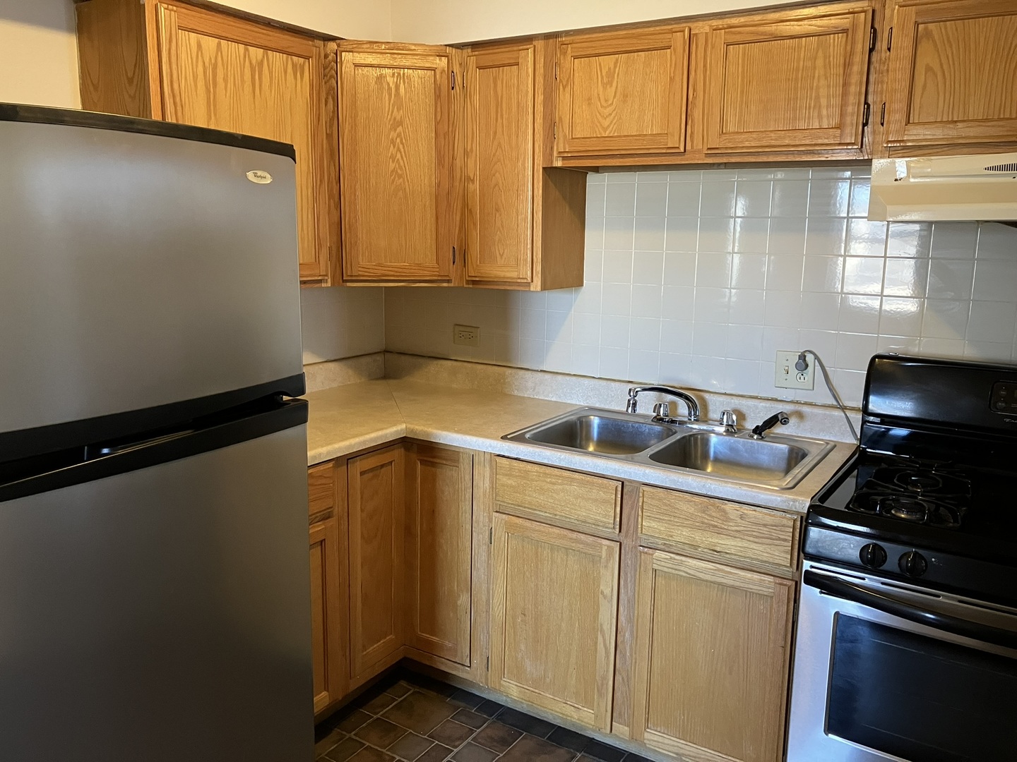 2404 East 79th Street Chicago, IL 60649 - Photo 9 of 22 a kitchen with stainless steel appliances granite countertop a refrigerator sink and cabinets