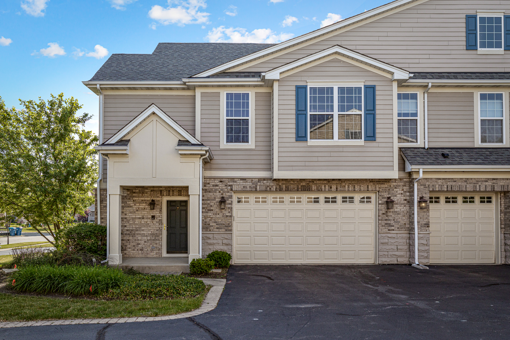 1346 Scarboro Road, Unit 706 Schaumburg, IL 60193 - Photo 1 of 1 a front view of a house with a yard