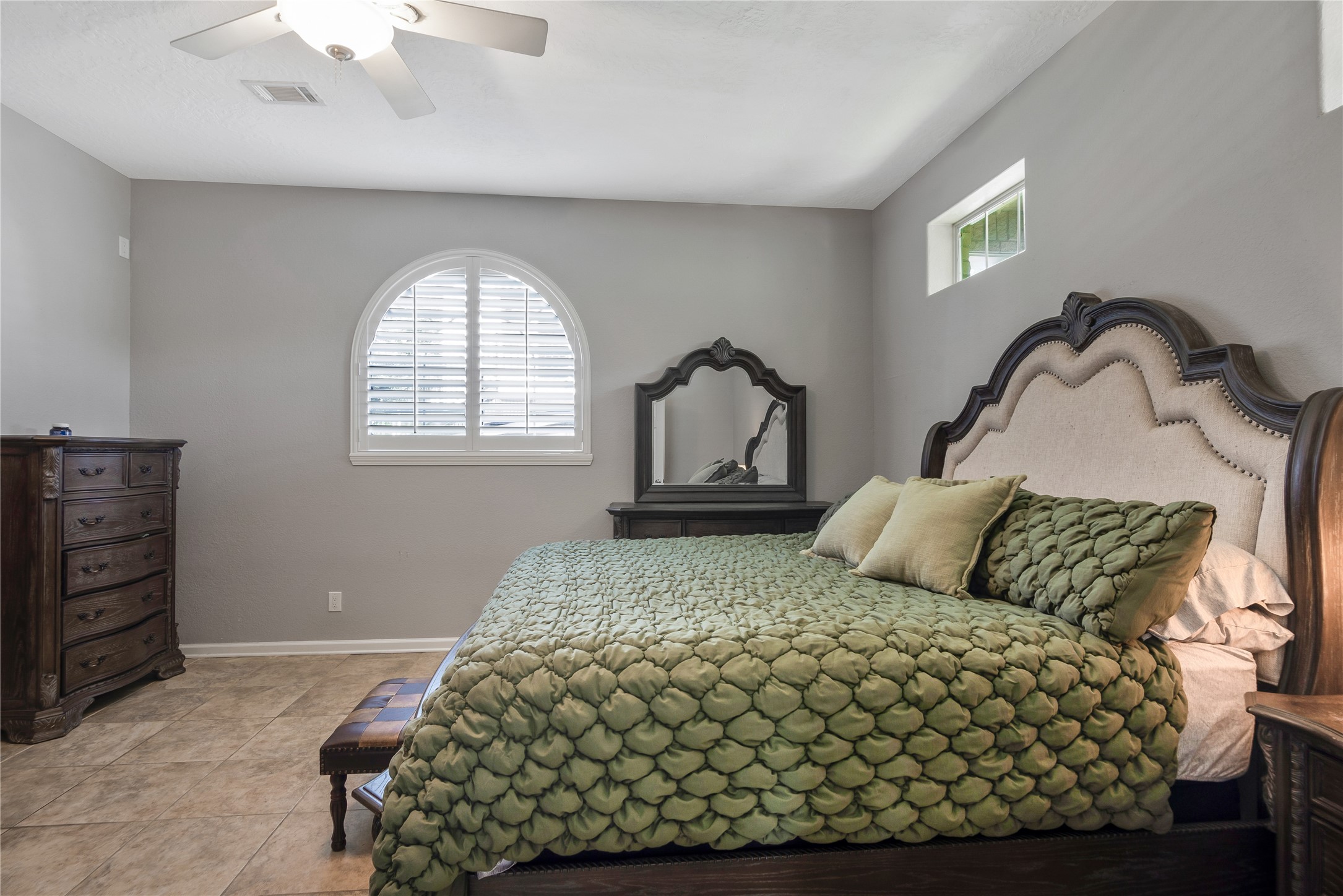 13914 Skinner Road Cypress, TX 77429 - Photo 30 of 50 Mother In Law Suite: Spacious bedroom with hardwood floors, ceiling fan, and arched window bringing in natural light.