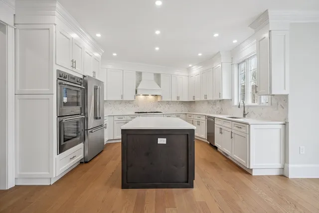 a kitchen with a sink stove and refrigerator