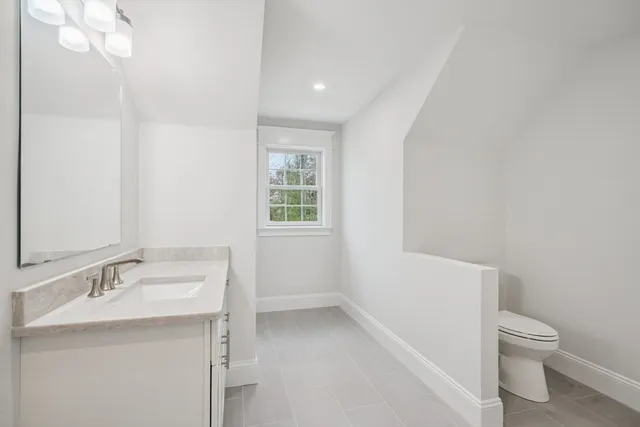 a bathroom with a sink toilet and vanity