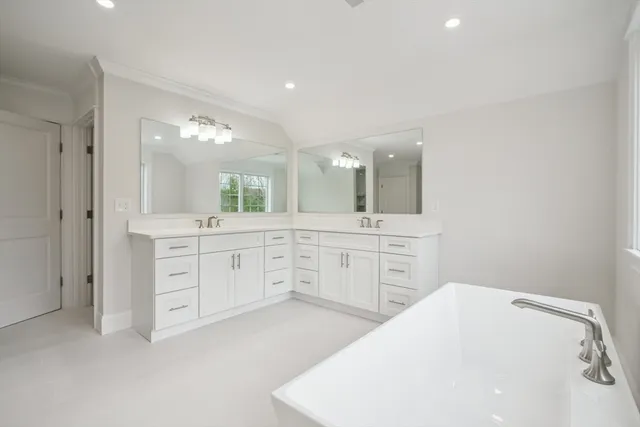 a spacious bathroom with a double vanity sink mirror and