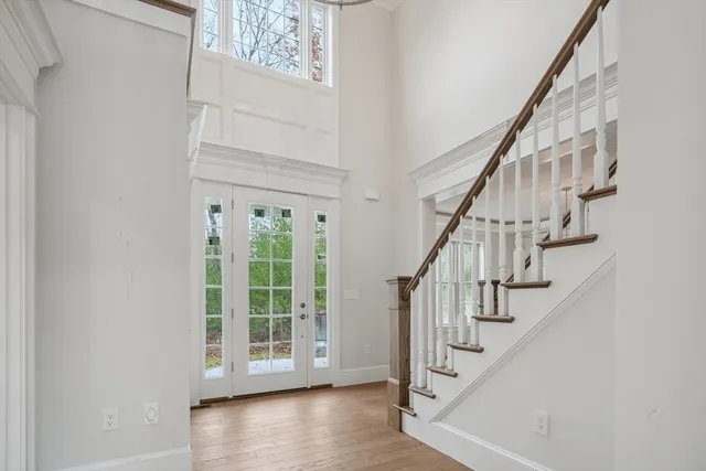 a view of entryway with wooden floor and front door