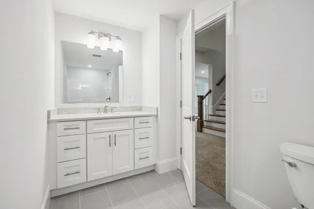 a bathroom with a double vanity sink and mirror