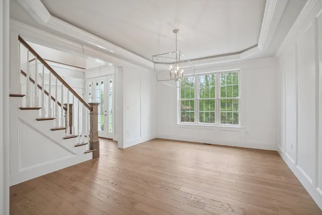 a view of an entryway with wooden floor door and windows