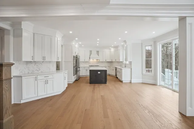 a large kitchen with a lot of counter space and stainless steel appliances