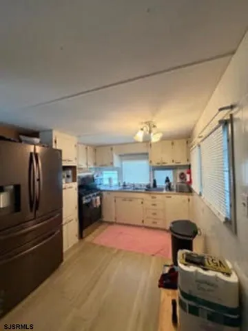 a kitchen with refrigerator and cabinets