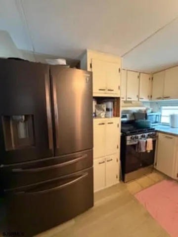 a kitchen with stainless steel appliances and refrigerator