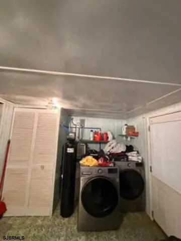 a utility room with closet dryer and washer