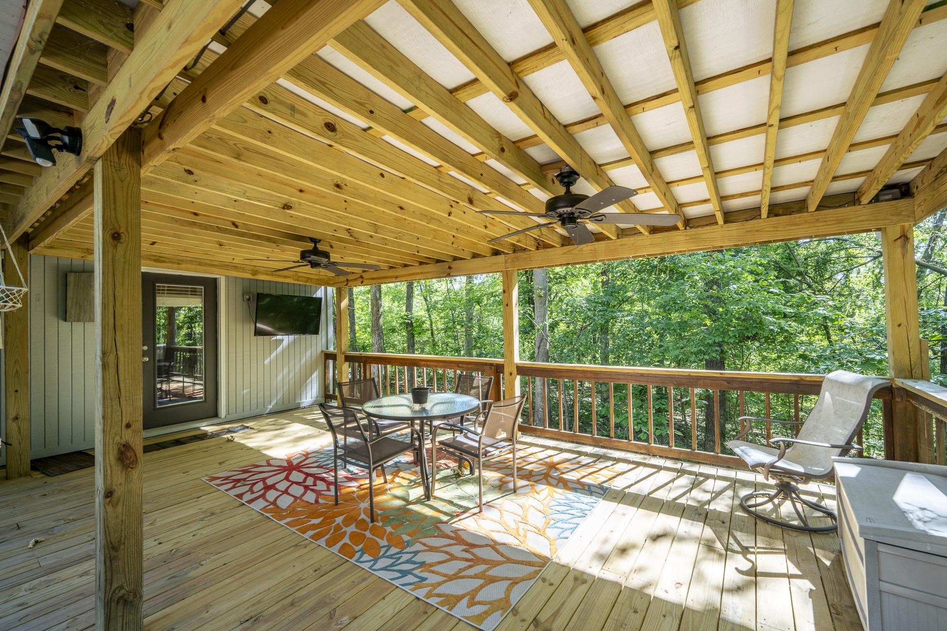 80 Contreau Road Counce, TN 38326 - Photo 22 of 28 a view of a patio with a table chairs and wooden floor